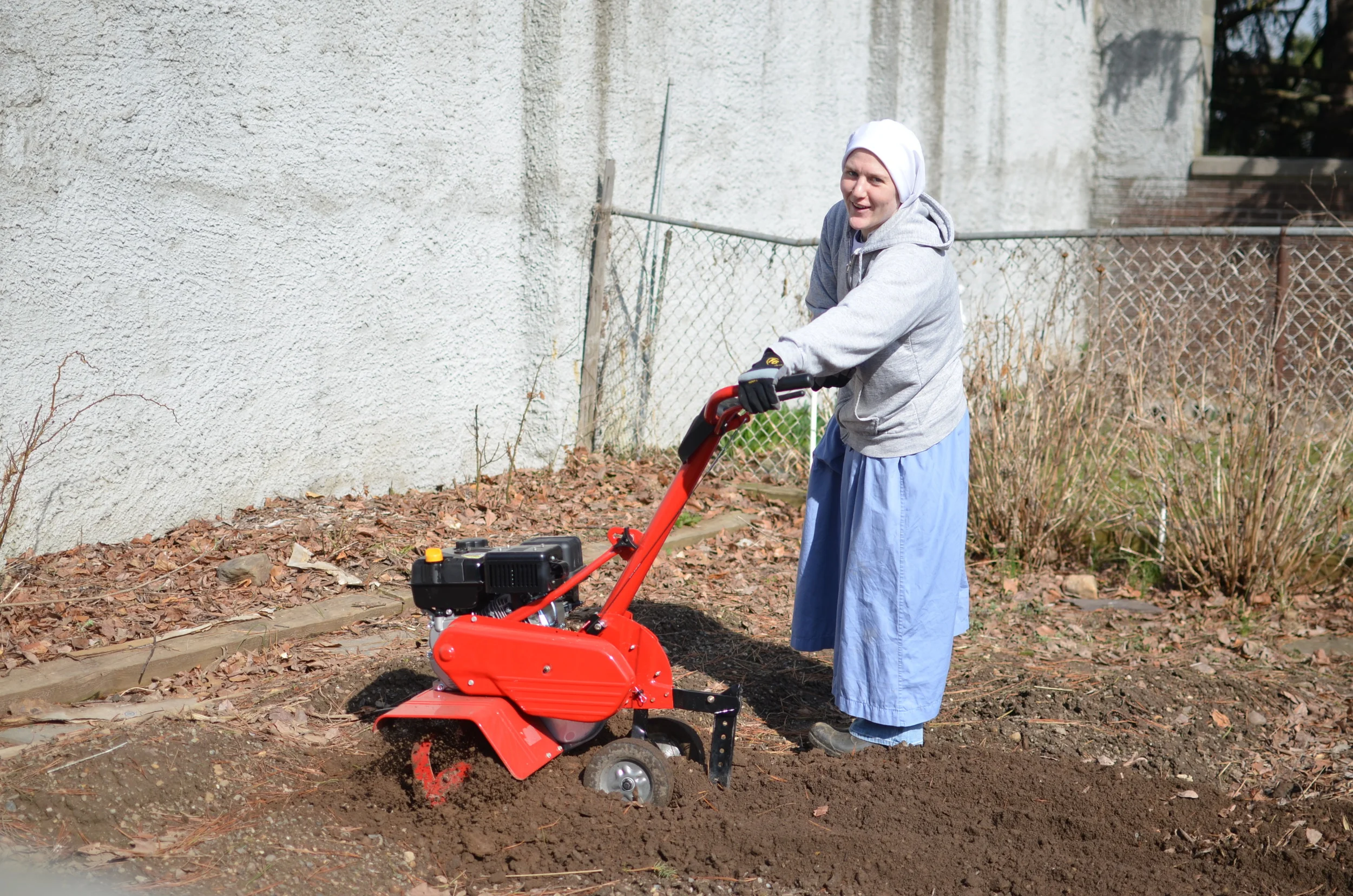 Sr. Mary Magdalene is happy to till the garden for another year of planting!