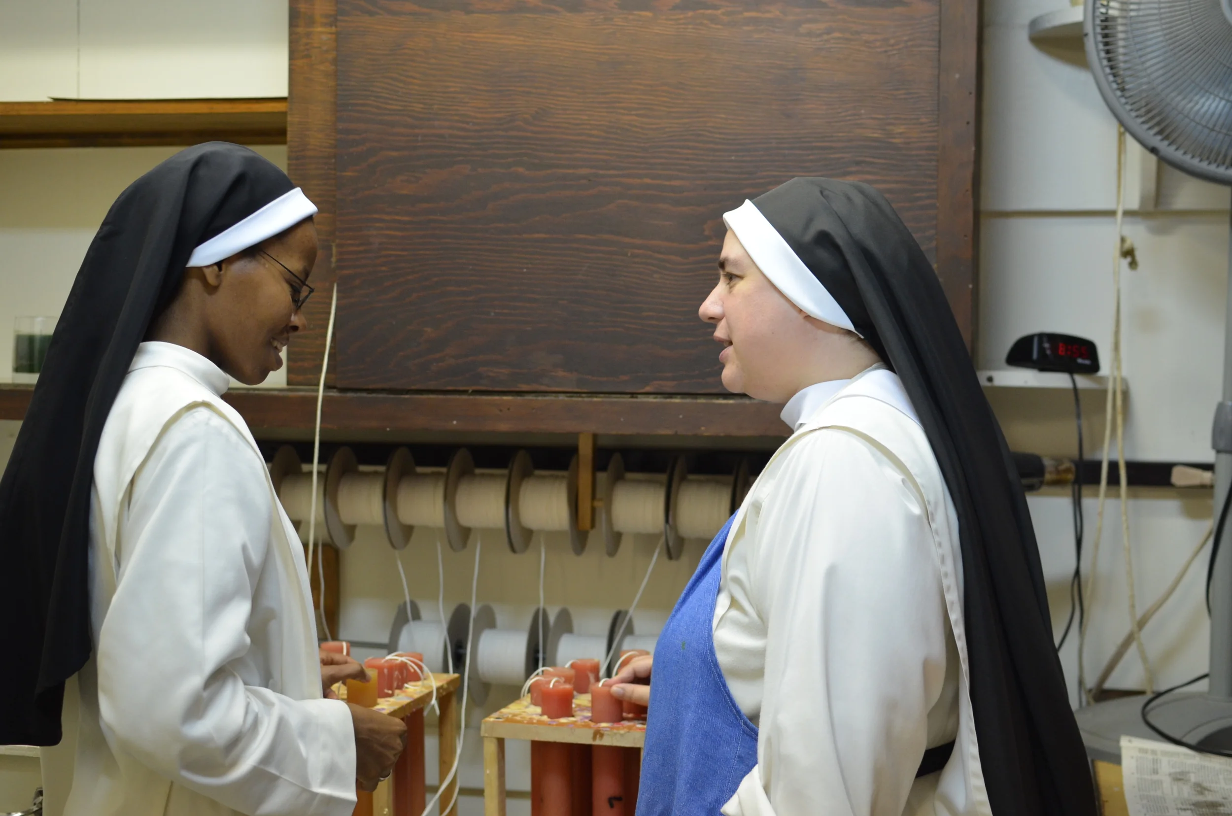 Sr. Mary Catharine (R) shows Sr. Francisca our candle department. Sr. Francisca makes candles at her monastery in Kenya.