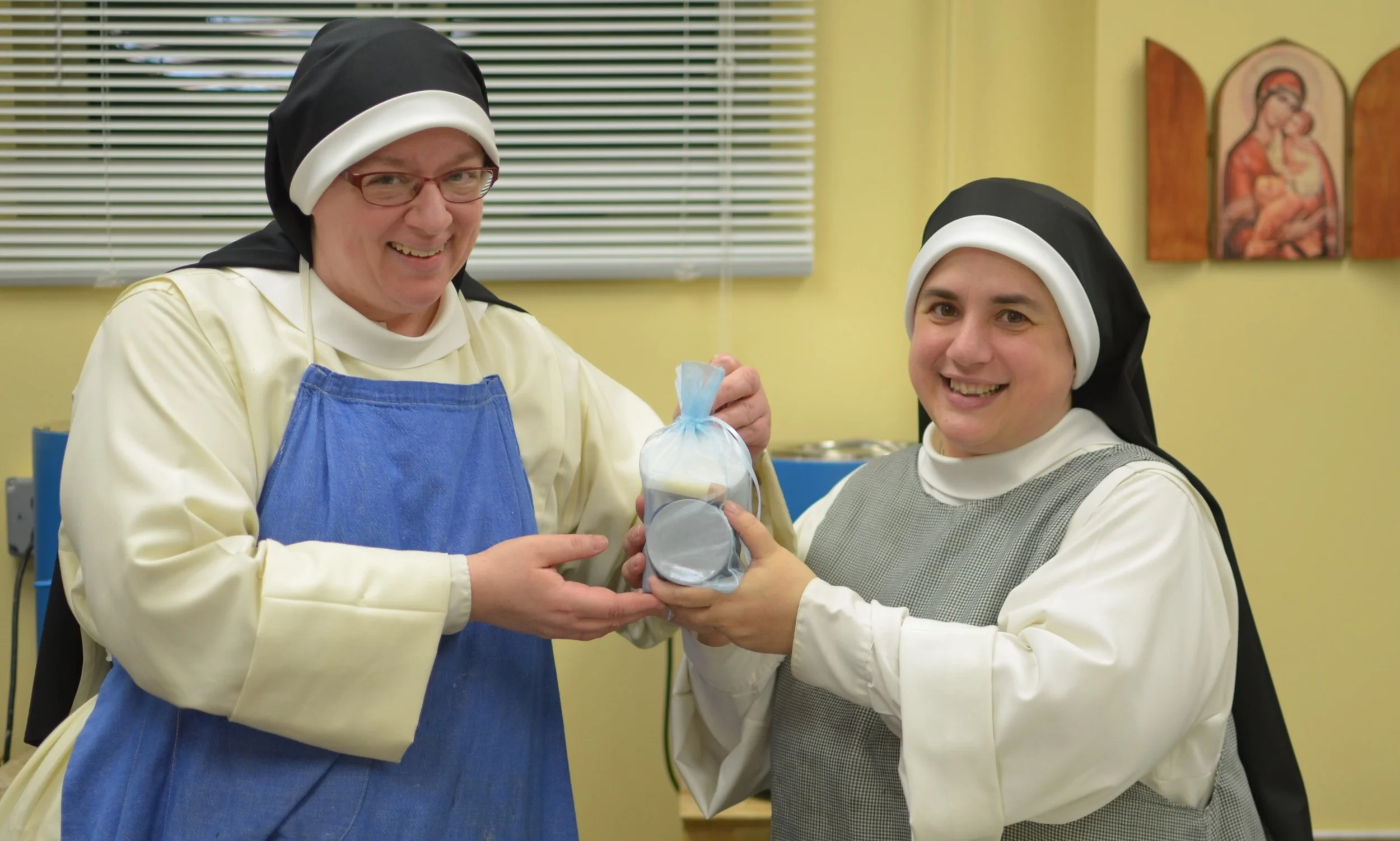 Sr. Mary Catharine presents the winning prize to Sr. Judith Miryam. A bag of "mystery" Seignadou Soap Products!