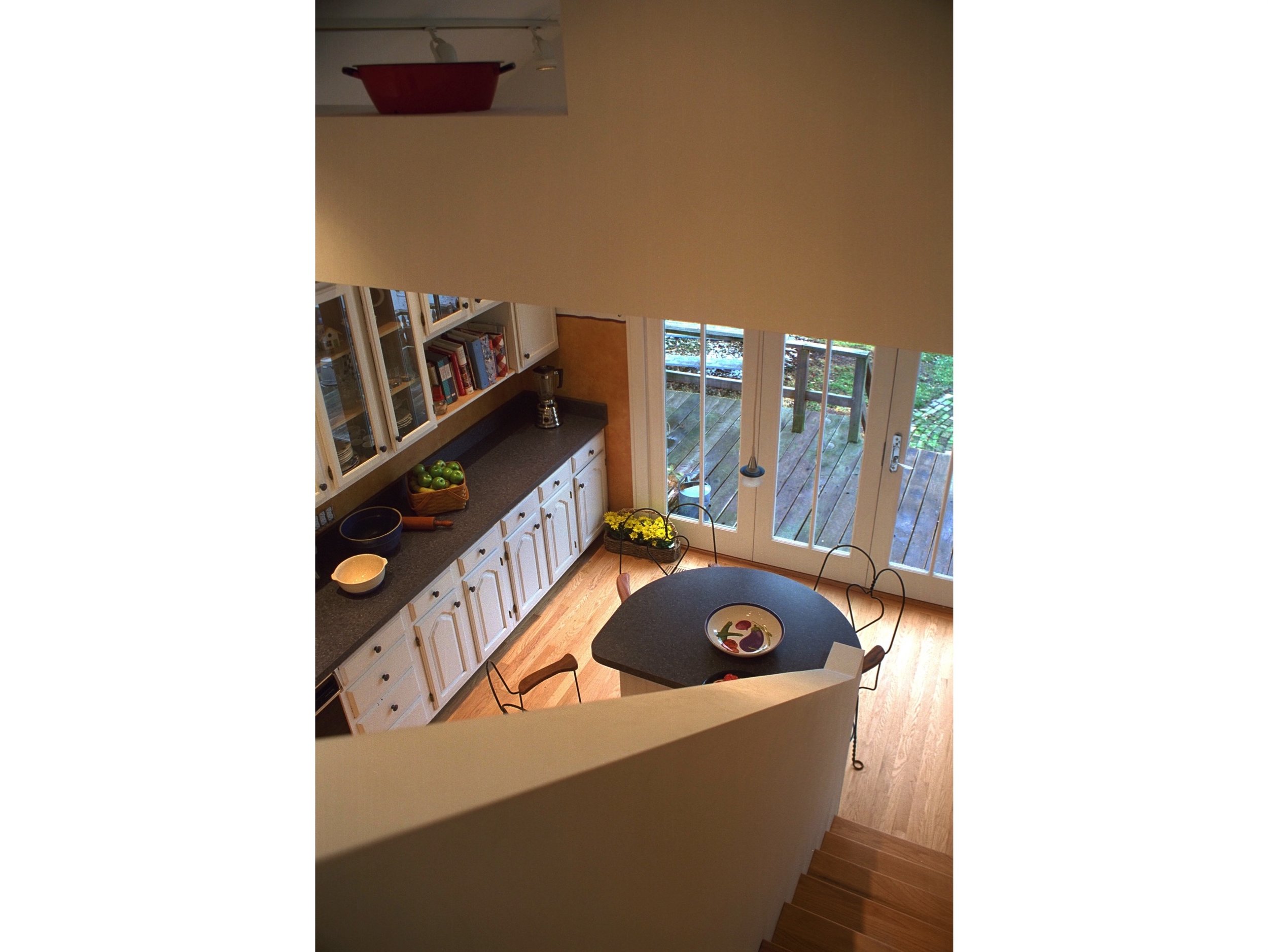  Removing an existing ceiling allows an overlook of the kitchen from the master bedroom suite. 