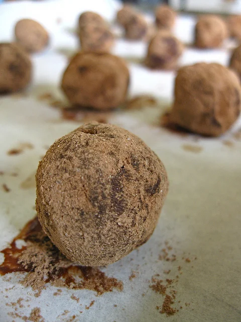 Thursday, October 7, 2010 Garlic Chocolate Truffles Makes 30 Truffles Ingredients 8 oz. 60% bittersweet chocolate 1/3 cup dutch-process cocoa 1/3 cup heavy whipping cream 6 Tbsp. unsalted butter 2 Tbsp. minced garlic Bring your cream to a simmer. Chop butter into smaller pieces, add to cream, and stir until melted. Then add your chocolate chips, stirring until smooth. Remove from the heat and pour into a shallow bowl or dish. At this point, mix in your raw, finely minced garlic. If you'd like to make a few flavors, separate into different bowls, and then cut down the garlic proportionally. You can also add a liqueur or even a jam to some of the chocolate. Allow ganache to cool, then cover, and refrigerate until firm--about 2 hours. You can do this 1 to 2 days before. If you go over the 2 hours, allow tosit out for about 30 minutes to make scooping easier. Using a melon baller, spoon, or even your teaspoon, scoop the ganache and roll into 1-inch balls. Your hands are going to get chocolaty, but if you feel like too much is ending up on your fingers, place the ganache in the freezer for a few minutes, and lick your fingers while you wait. After you've completed your balling, roll in a shallow bowl filled with cocoa powder or chopped nuts. The Baking Barrister