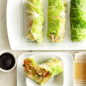 Napa Cabbage Spring Rolls By Midwest Living/Food Yield: 8 spring rolls (16 pieces) Hands On 25 mins Total Time 1 hr Once assembled, these fresh vegetarian appetizers benefit from allowing the surface to dry a little, so making them an hour or so in advance of serving is a good idea. The recipe comes from chef Kevin Shinn of Bread and Cup in Lincoln, Nebraska. ingredients 1/2 cup Arborio rice or long grain rice 1 tablespoon sea salt or kosher salt 4 cups ice cubes 1 head Napa cabbage or savoy cabbage 1 cup shredded or grated carrot 1/2 cup finely chopped green onion 2 tablespoons snipped fresh flat-leaf Italian parsley 1 tablespoon sesame oil (not toasted) 1/4 teaspoon lime zest 2 teaspoons lime juice 1/2 teaspoon sea salt or kosher salt 1/4 teaspoon ground black pepper Soy sauce or teriyaki sauce directions For rice: In a medium saucepan, bring 1 cup water to boiling. Slowly add rice and return to boiling; reduce heat. Simmer, covered, about 15 minutes or until most of the water is absorbed and the rice is tender. Remove from heat. Let stand, covered, for 5 minutes. Uncover; let rice cool. For wrappers: In a large pot, bring 12 cups water and the 1 tablespoon sea salt to boiling. Meanwhile, place the ice in a large bowl with 8 cups cold water. Remove eight outer leaves from cabbage. Make a cut through each leaf at the base, trimming out some of the woody stem. Set the remaining head aside. Carefully place trimmed leaves in the boiling water for 30 to 60 seconds or until just wilted, then transfer them to the ice water for 60 seconds. (Tongs are the best tool for the job.) Remove leaves from cold water one at a time, and lay flat on a cloth towel. Set aside to dry. For filling: From the remaining cabbage, finely chop enough to measure 13/4 cups. In a large bowl, combine the chopped cabbage, carrot, green onion, parsley, sesame oil, lime zest, lime juice, the 1/2 teaspoon sea salt and the pepper. About one hour before serving, assemble rolls. First, squeeze out any excess water from the filling. Then lay a blanched cabbage leaf flat on the counter with the base end toward you. Place 1/4 cup of the filling in the center of a leaf; place 2 tablespoons of rice on top of the filling. Fold stem end and sides over filling and roll up tightly, taking care not to tear. Place on a serving dish, seam side down. Let sit for about an hour. If you like, cut each roll in half diagonally to reveal the filling. Serve with soy sauce for dipping. To serve, if you like, cut each roll in half crosswise on a diagonal to make 16 pieces. Serve with soy sauce or teriyaki sauce.