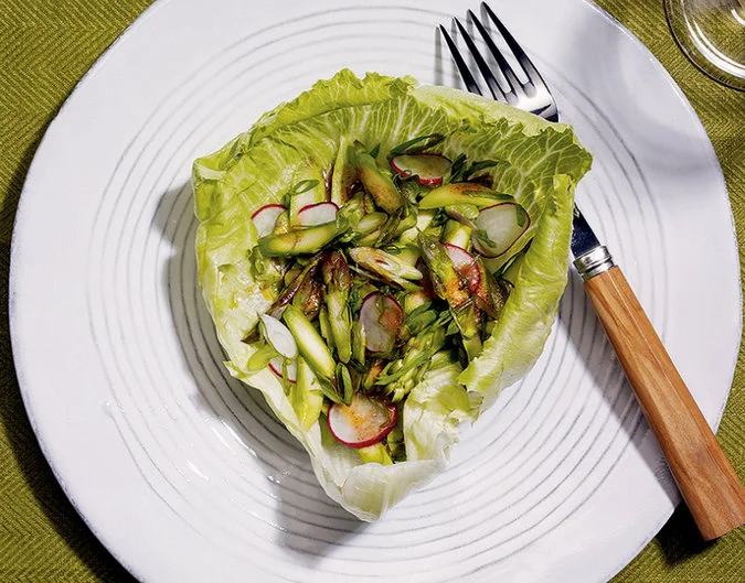 Raw Asparagus Salad AMANDA HESSER YIELD 4 servings TIME 15 minutes INGREDIENTS FOR THE FRENCH DRESSING: ⅛ teaspoon dry mustard ¼ teaspoon celery salt 1/16 teaspoon black pepper ½ teaspoon paprika ¼ teaspoon salt 1 ¼ teaspoons sugar Pinch dried thyme ¼ teaspoon crushed caraway seed ⅓ cup red-wine vinegar ⅓ cup vegetable oil 1 tablespoon ketchup ⅛ teaspoon Worcestershire sauce FOR THE SALAD: 2 cups trimmed and finely slicedasparagus (about 1 pound) 2 tablespoons finely slicedscallions, green and white parts ¼ cup thinly sliced radish ½ teaspoon salt 4 medium sized Boston or bibblettuce leaves, washed PREPARATION Make the dressing by combining the mustard, celery salt, pepper, paprika, salt, sugar, thyme and caraway seed in a medium bowl. Whisk in the vinegar, oil and 3 tablespoons of water. Transfer cup dressing to a small bowl, then whisk in the ketchup and Worcestershire sauce. Cover tightly and chill the remaining dressing for use in other salads. Assemble the salad by lightly tossing the asparagus, scallions and radish together with the salt. Lay a cup-shaped lettuce leaf on each of 4 plates. Divide the mixture into the lettuce cups. Drizzle with the dressing. Serve immediately.