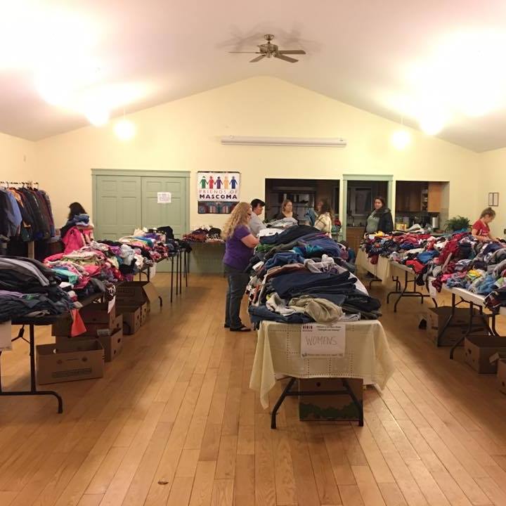Volunteers put the finishing touches on sorting and organizing clothing, jackets, blankets, and many other warm winter items.