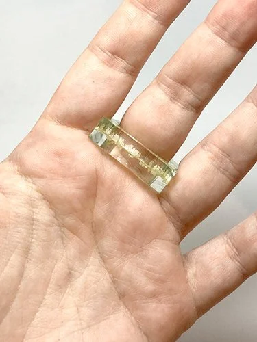 A modern ring made of layered plexiglass with a laser-engraved digital pattern