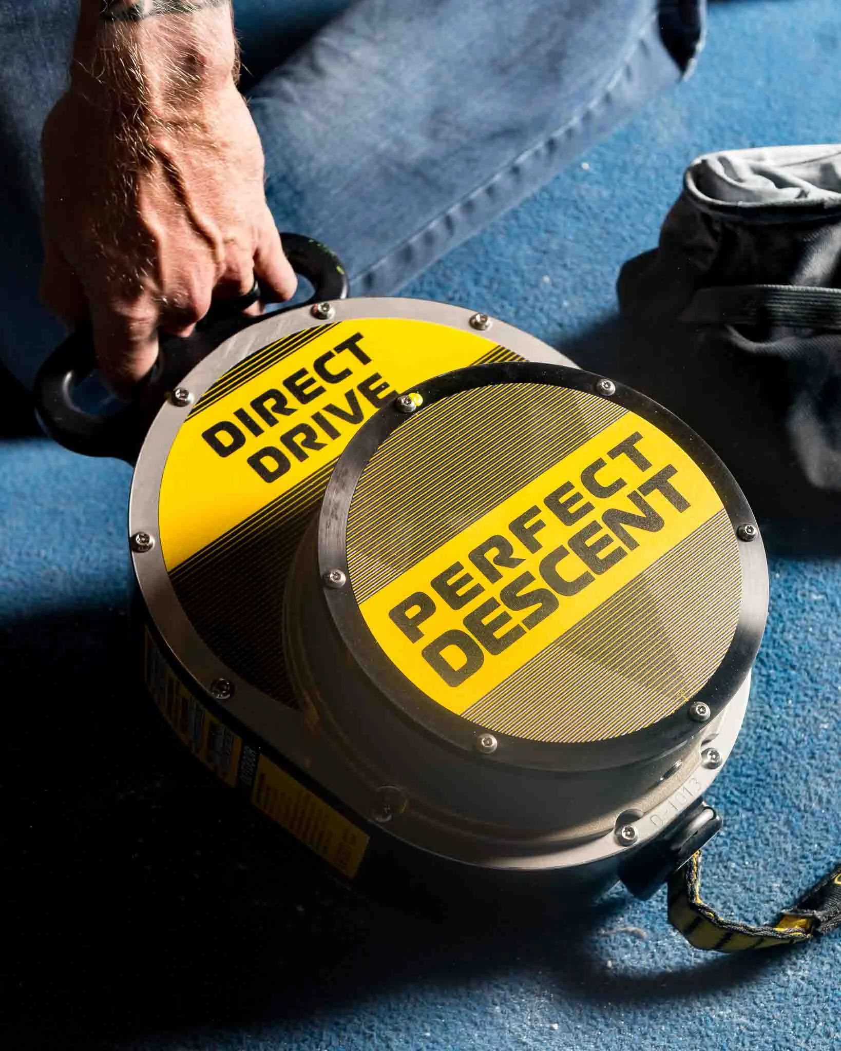 perfect-descent-direct-drive-auto-belay-man-holding-on-floor.jpg