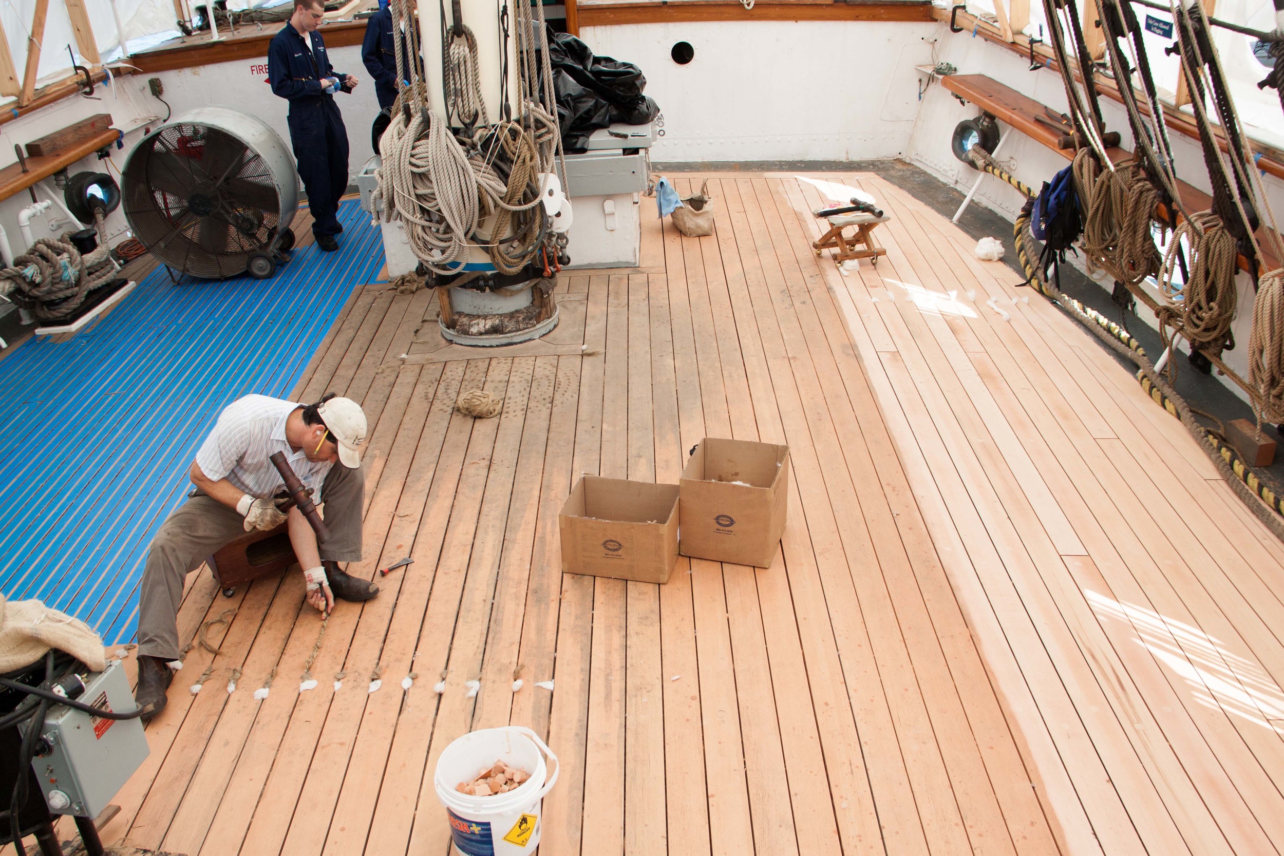 Andros caulking the deck