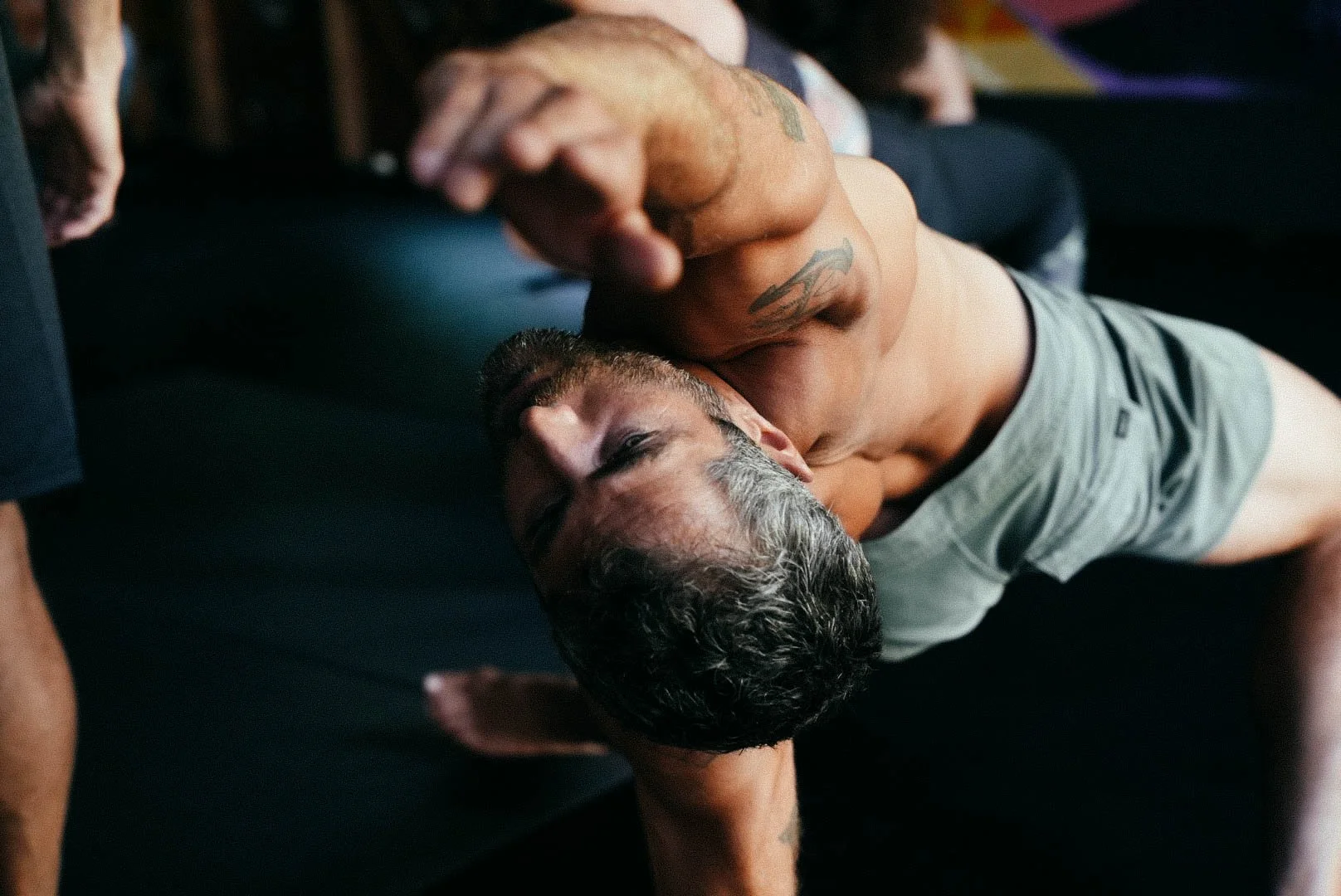 Man in a deep side stretch during a Lykos movement practice