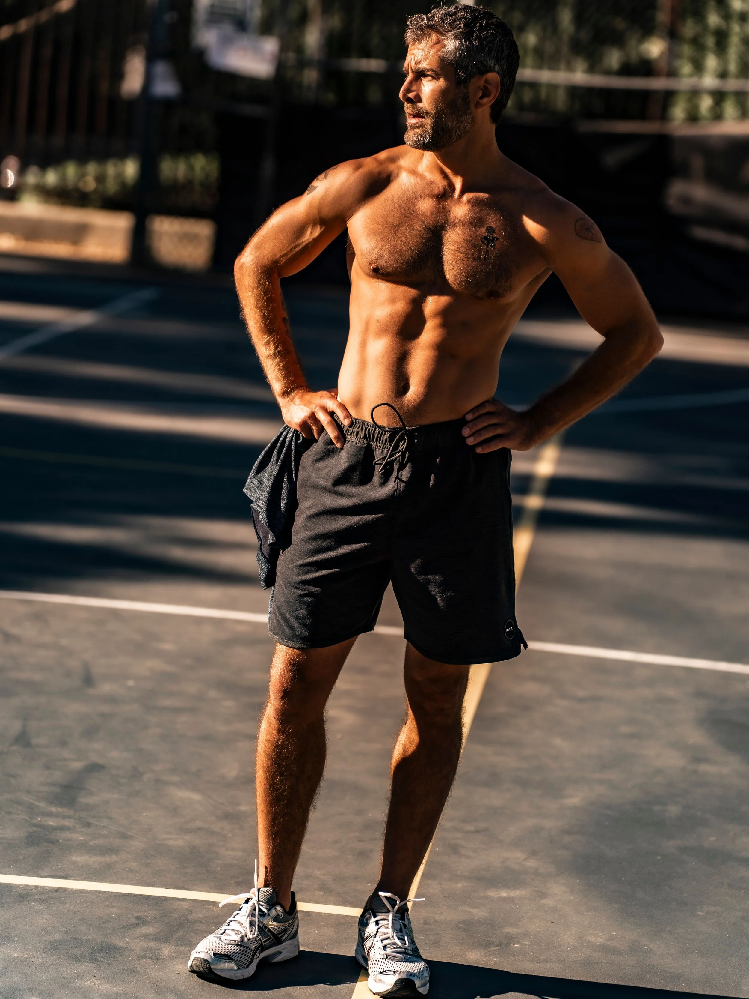 Nick Baga standing on an outdoor training court in athletic shorts and trainers