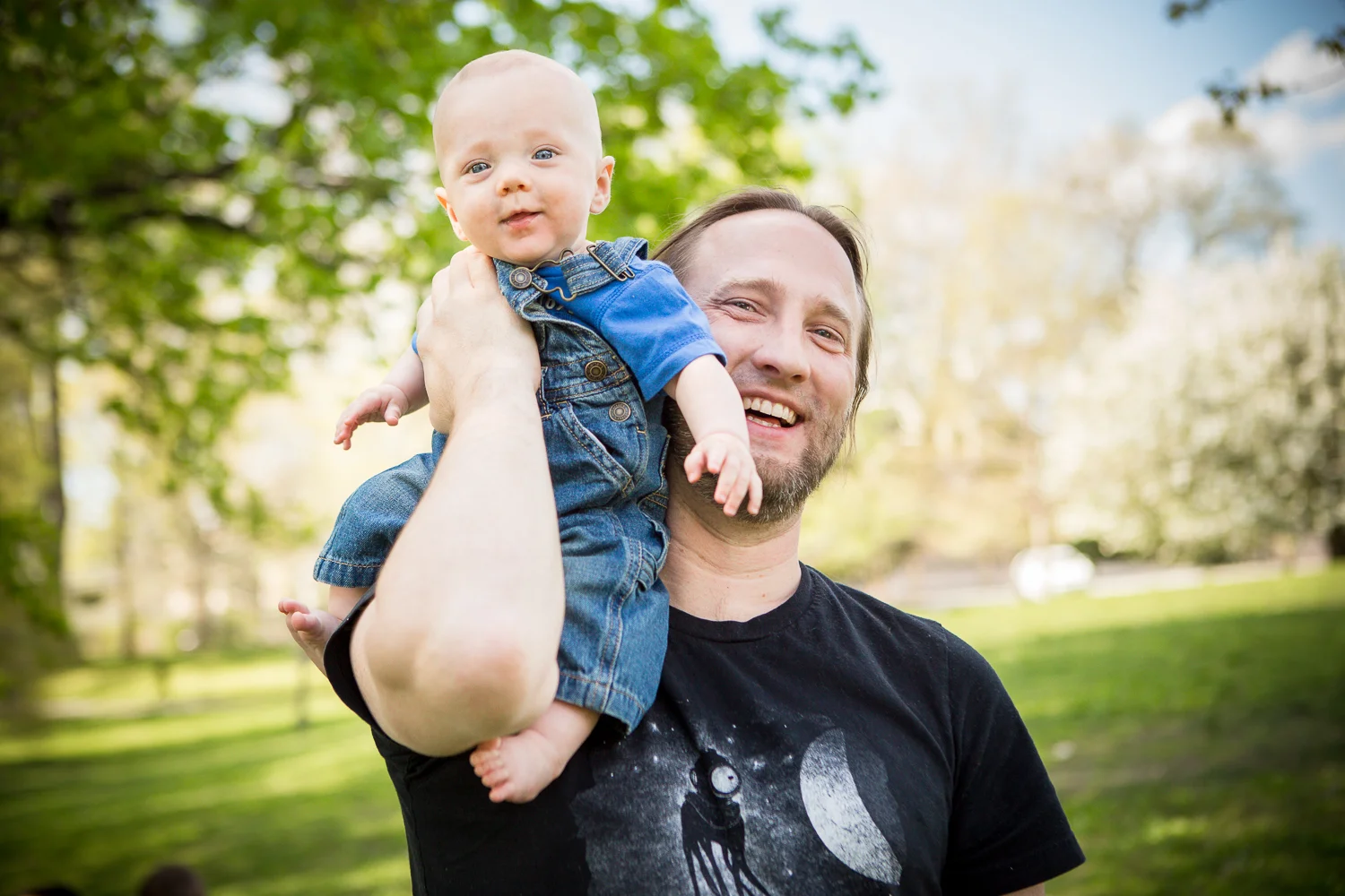 Dad carrying baby boy on his shoulder at Haverford College