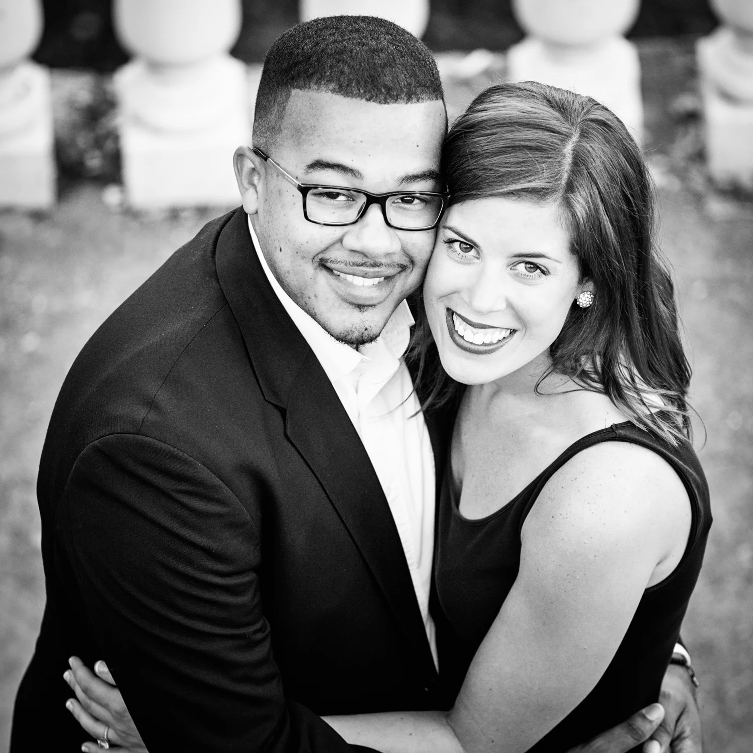 Black and white photograph of an interracial couple looking up into the camera