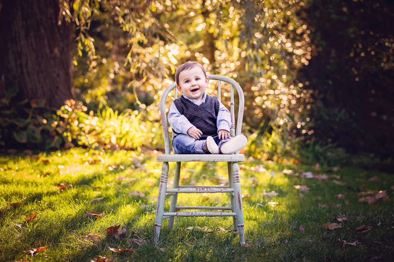 Outdoor fall portrait of a baby on an antique chair