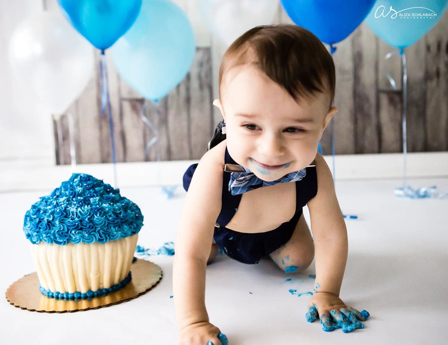 Crawling baby boy at his cake smash photo shoot