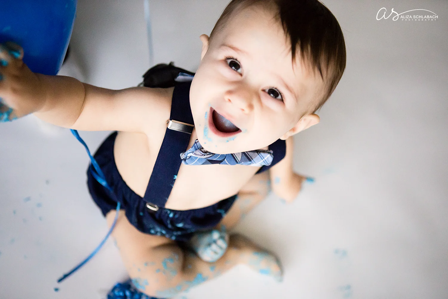 1 year old baby boy looking up at camera