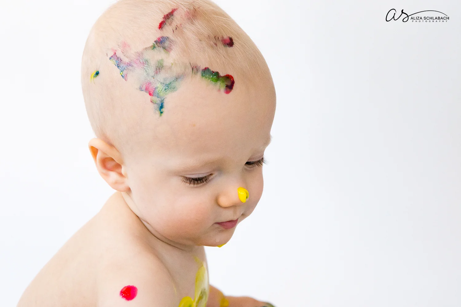 Photo of one year old boy with fingerpaint handprint on his head