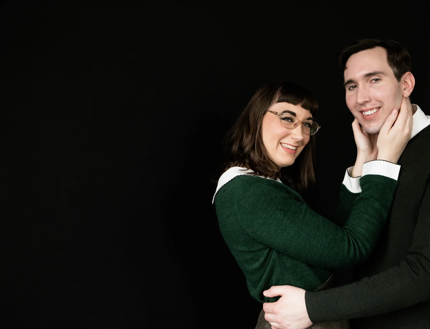 Cute couple portrait on black backdrop