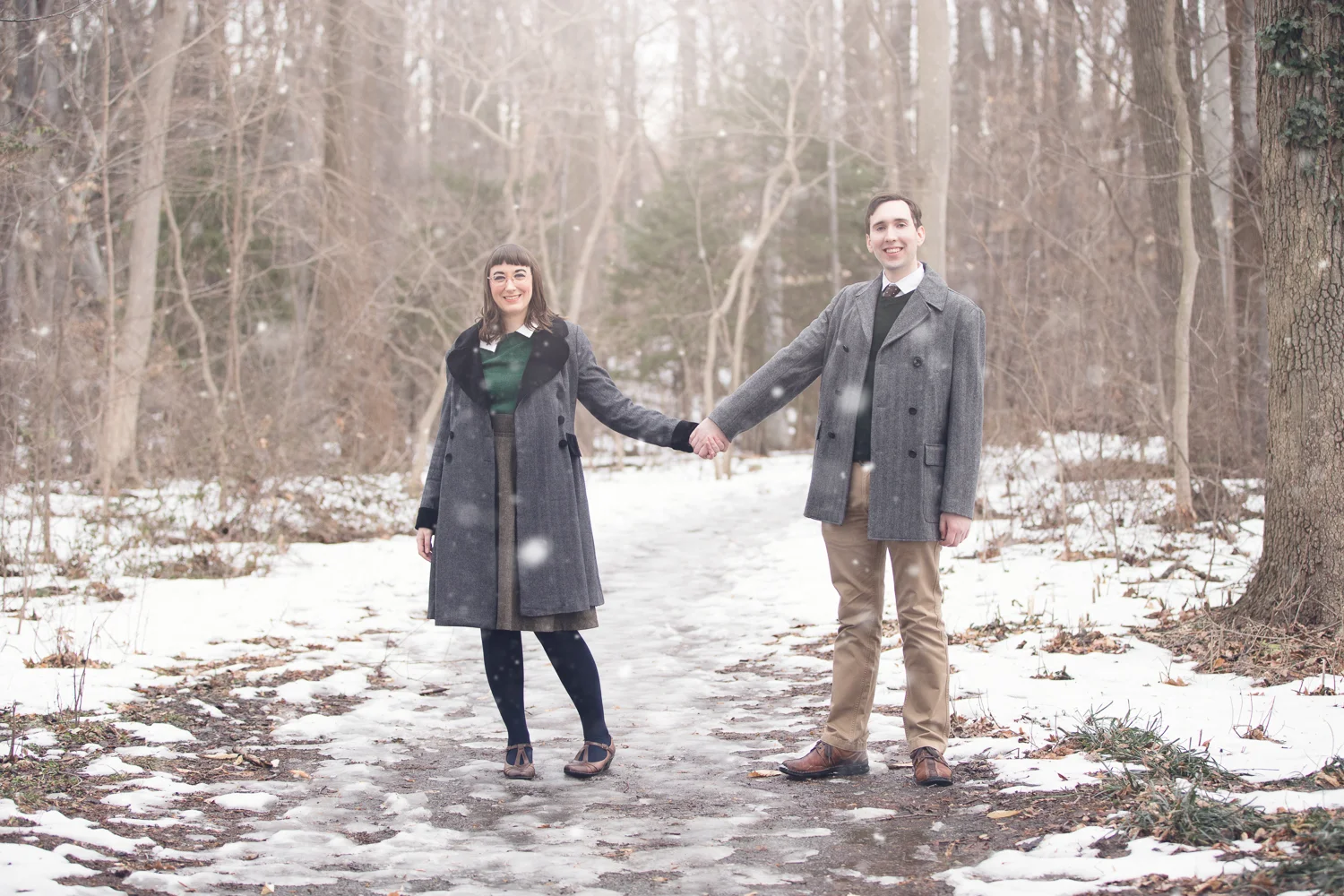 Photograph of cute vintage looking couple holding hands in the snow