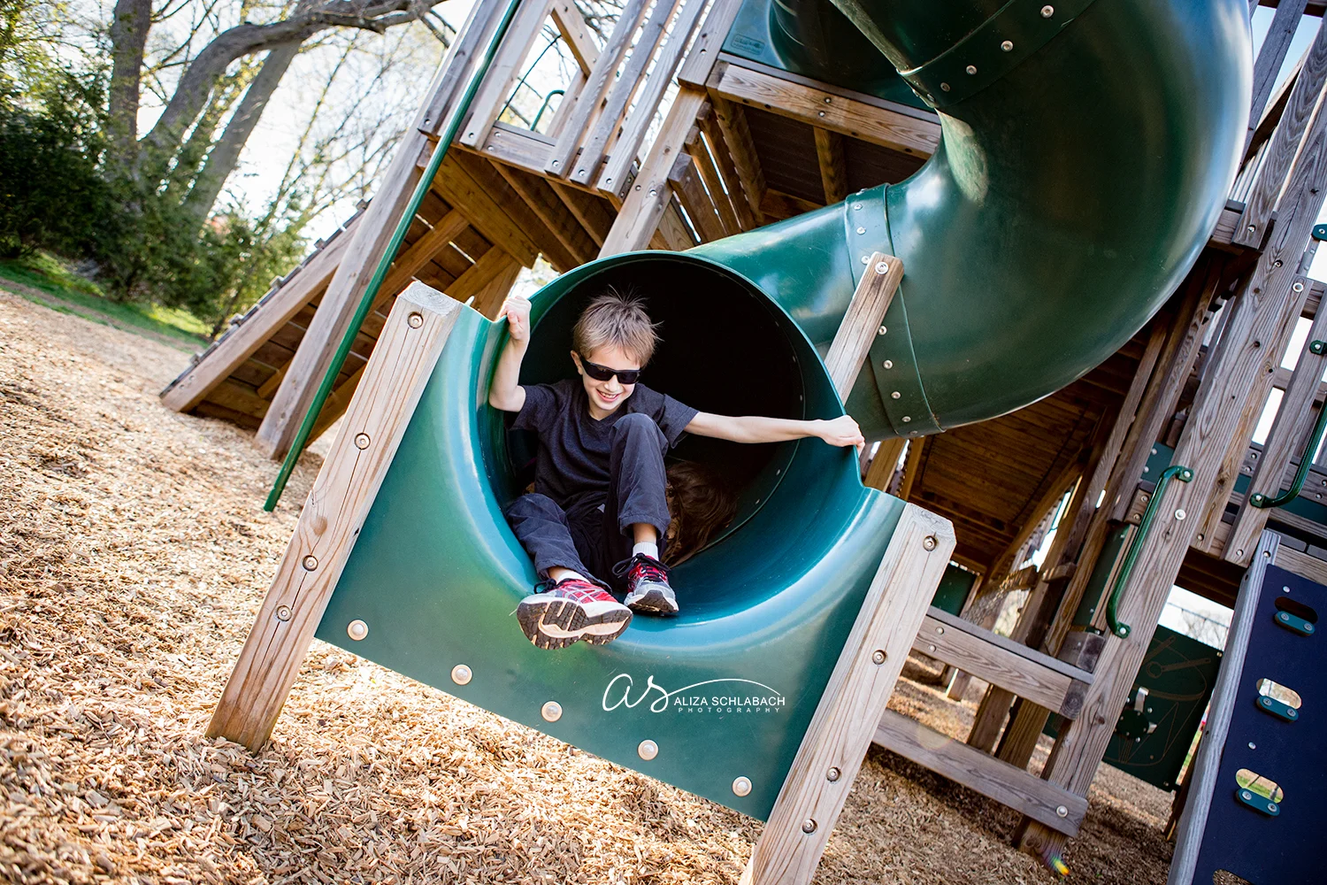 Photo of 9 year old boy coming out of tube slide