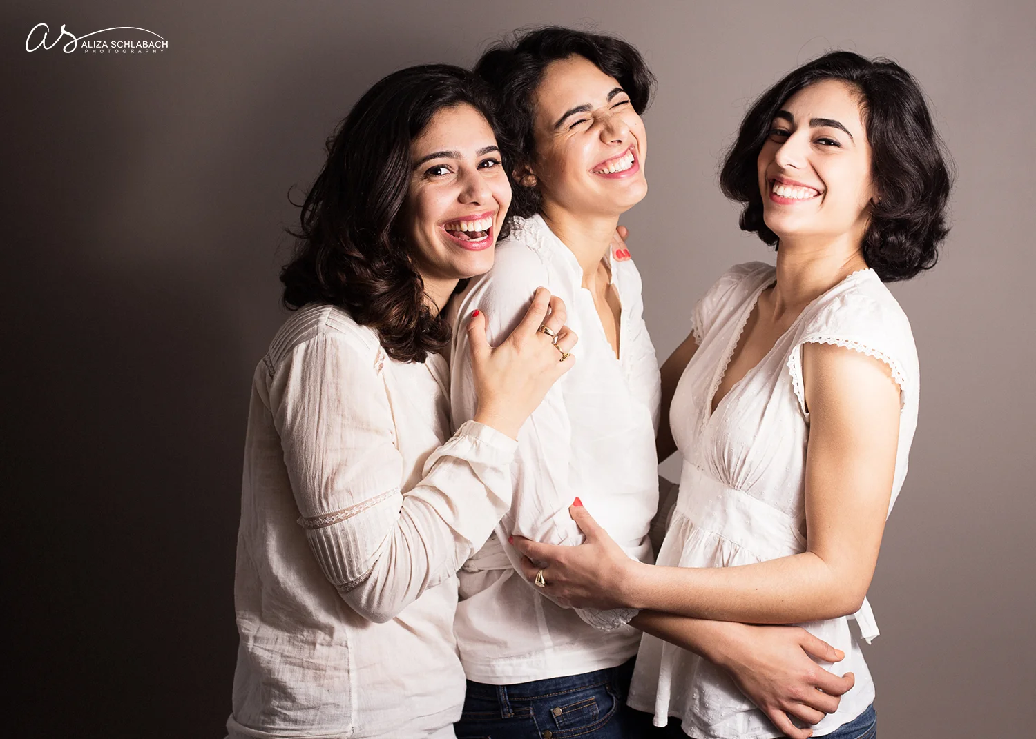 Photo of three grown sisters laughing