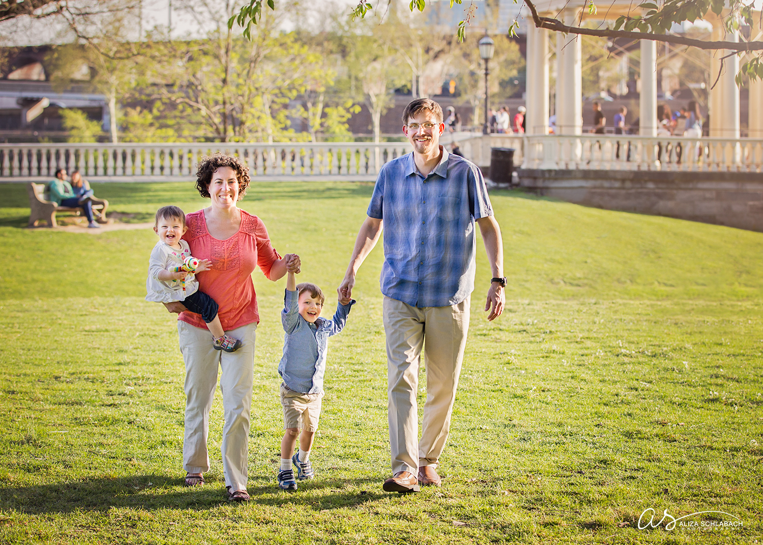 Family holding hands and walking by the Philadelphia Waterworks