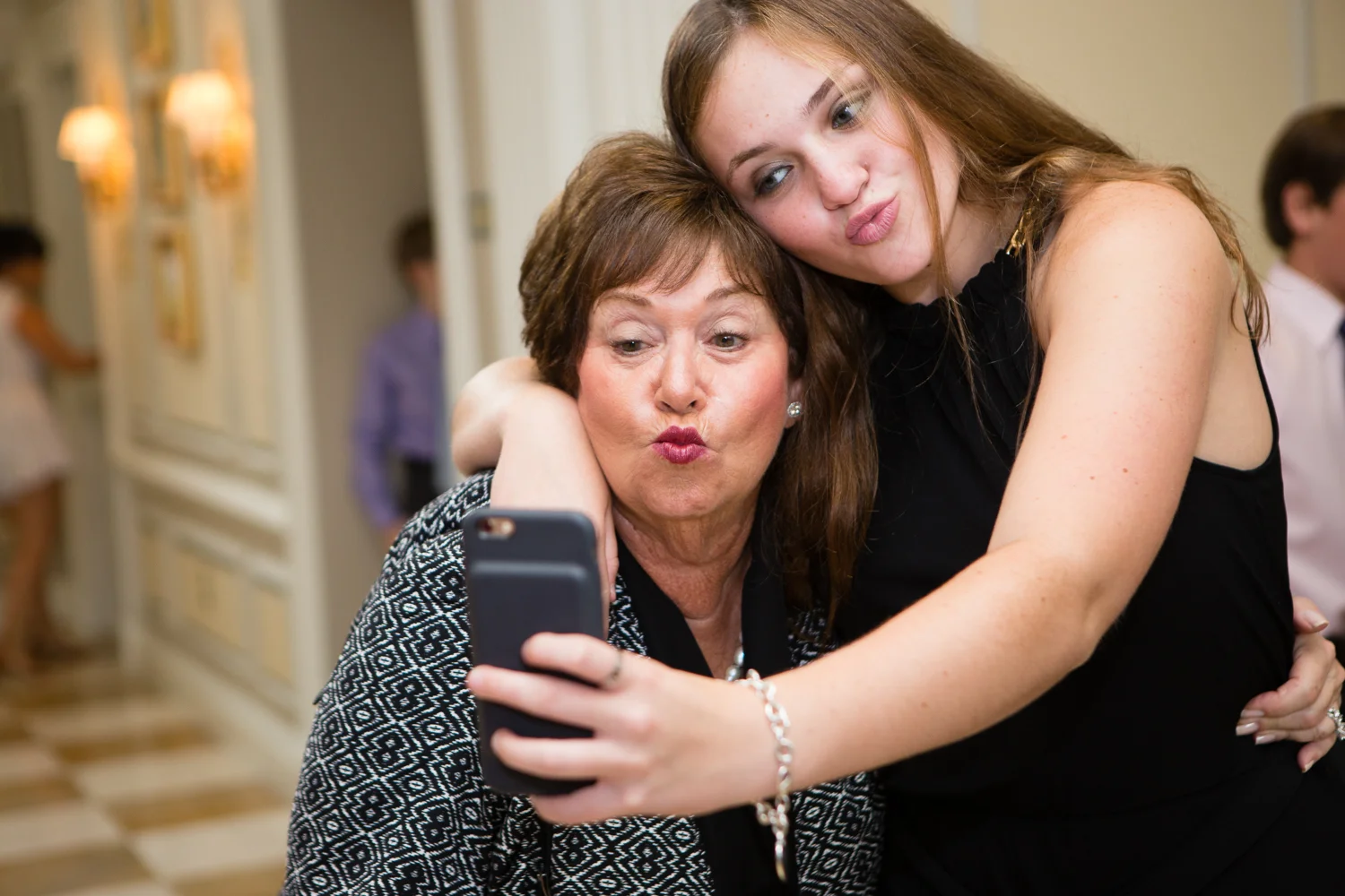 Photo of grandma and grandaughter taking a silly selfie