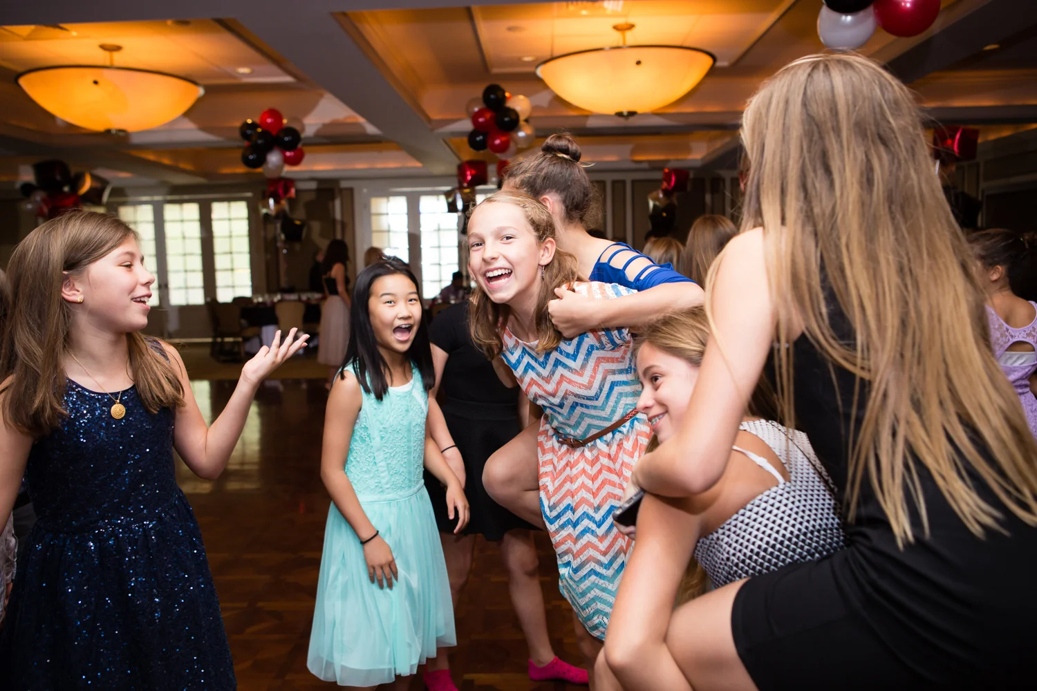 Photo of girls giving piggy back rides at mitzvah