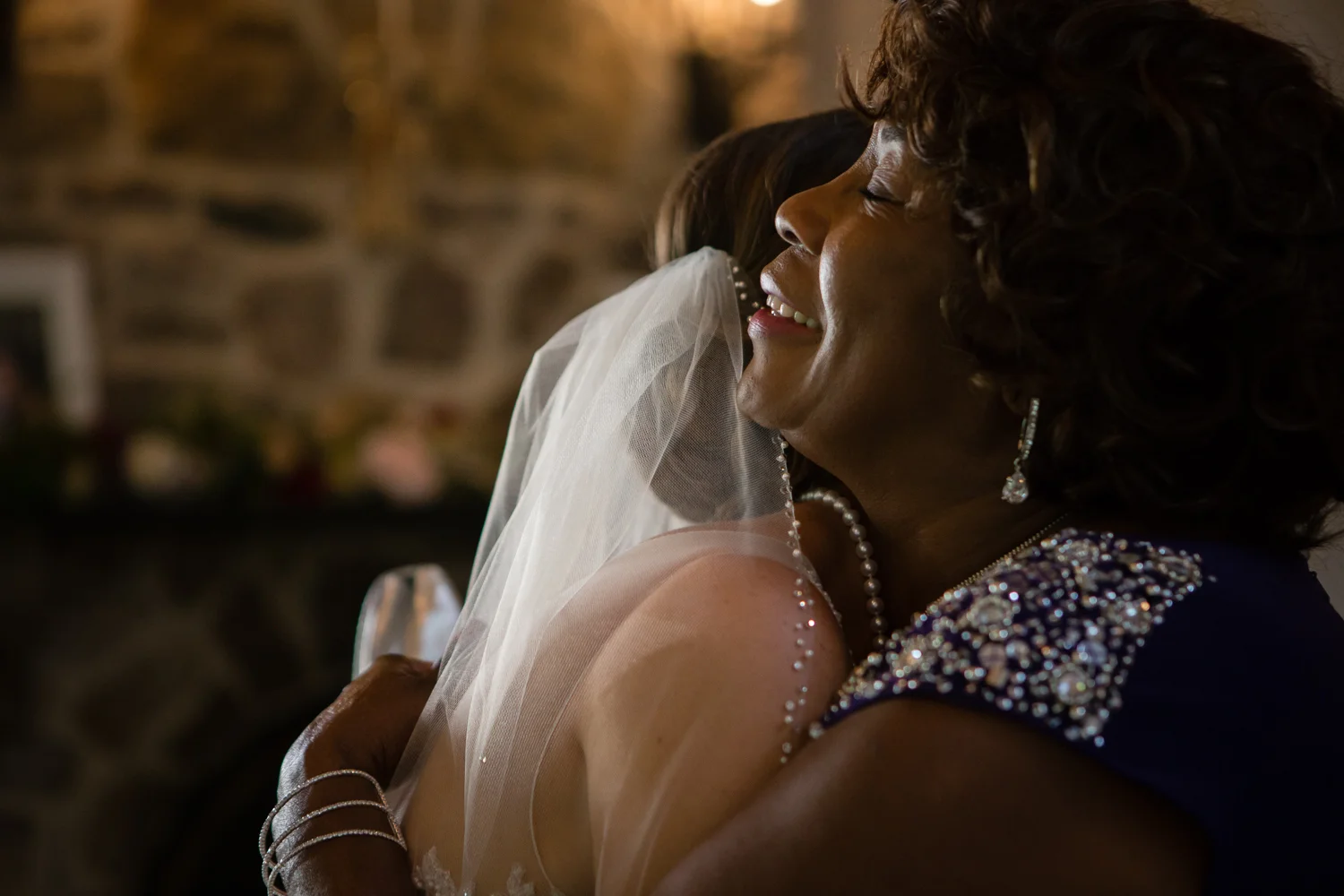 Bride hugging guest at wedding