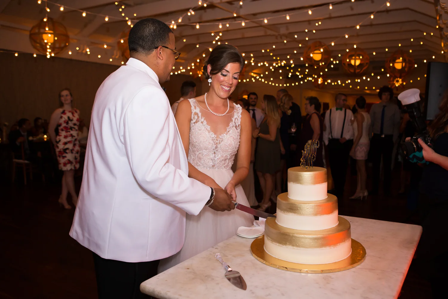 Photo of bride and groom cutting their wedding cake