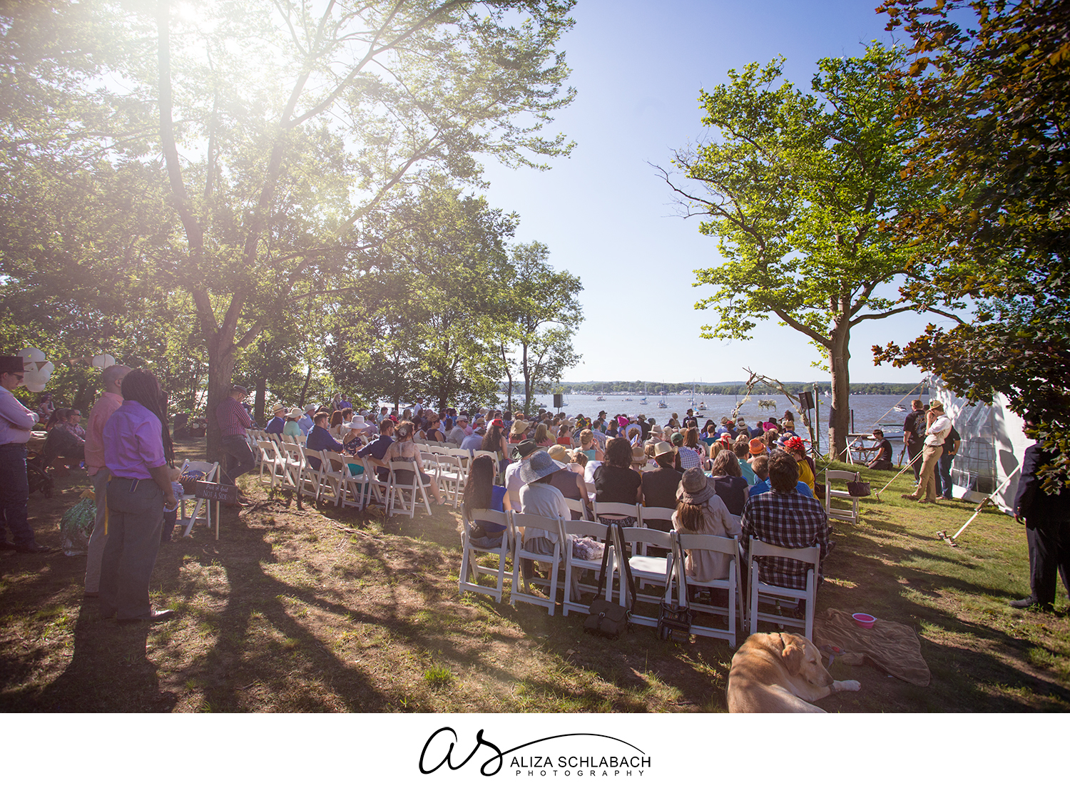Photo of outdoor wedding reception on the bay with a blue sky