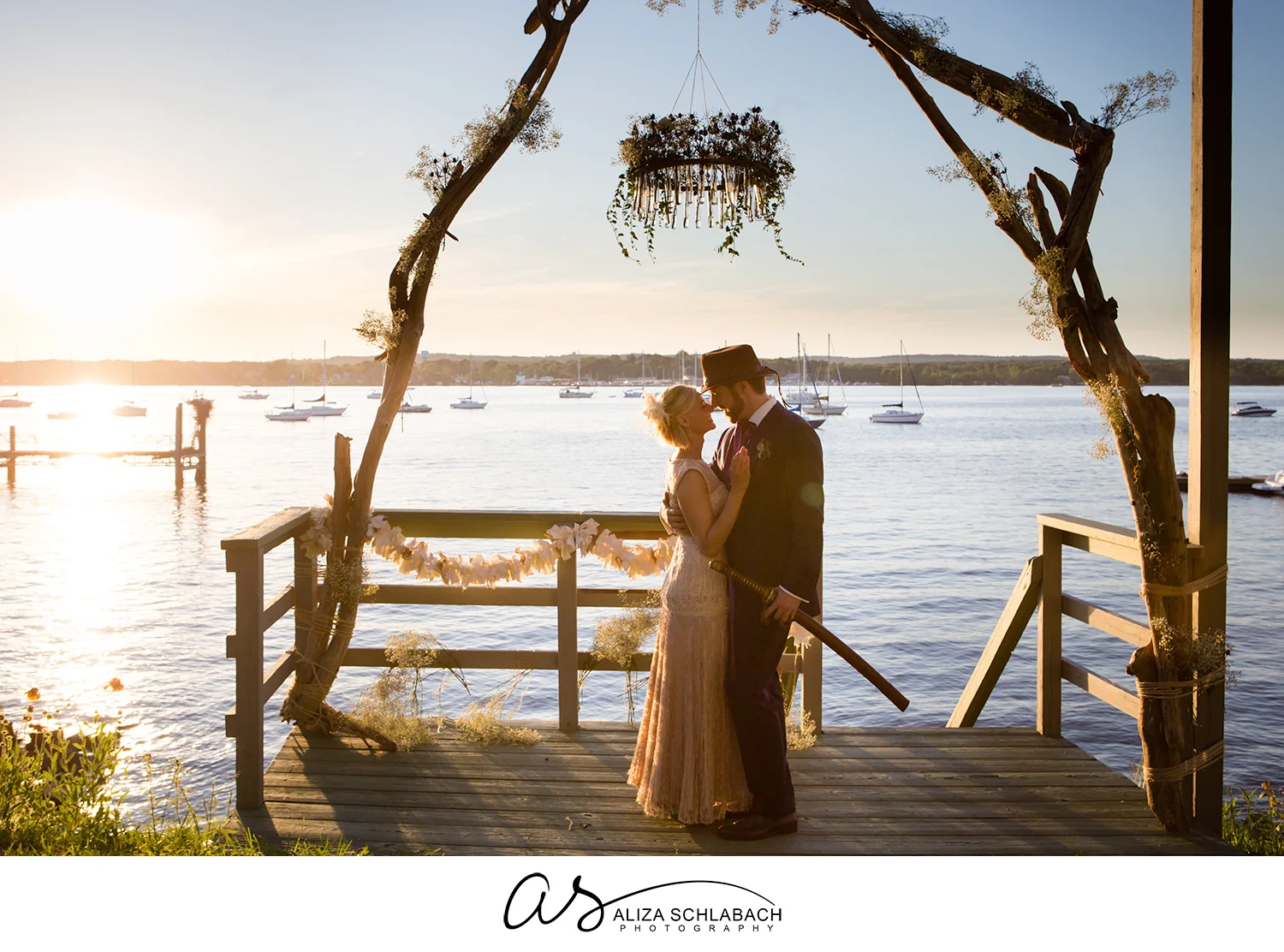 Photo of bride and groom at sunset at the dock overlooking the Chesapeake Bay