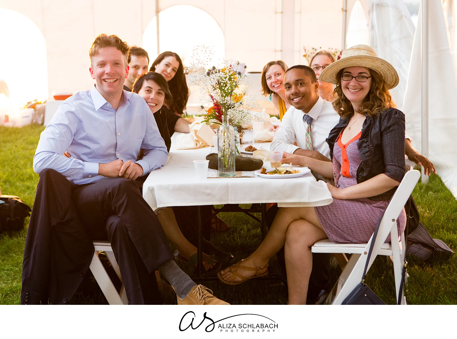Photograph of a table of wedding guests in a tent