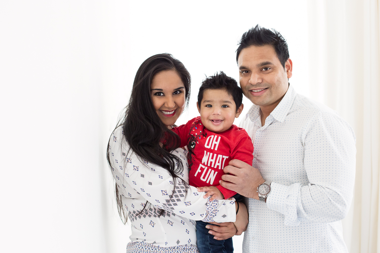 Backlit photo of parents with their baby boy