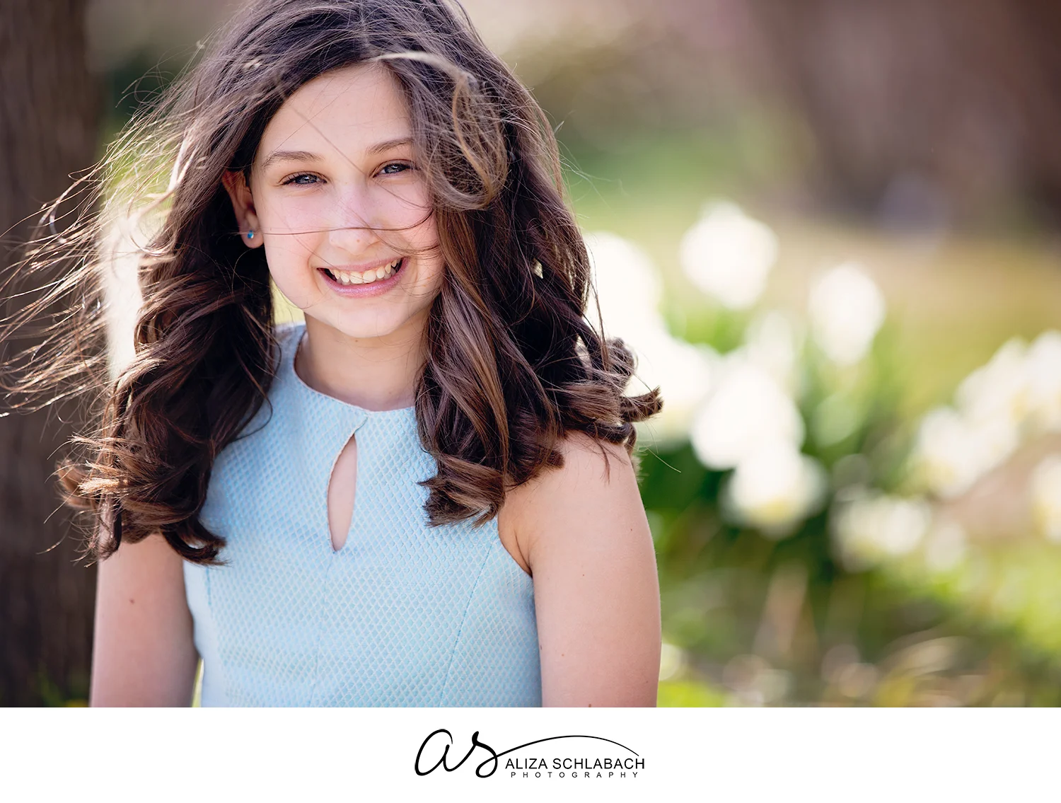 Beautiful portrait of a girl outside with windblown hair