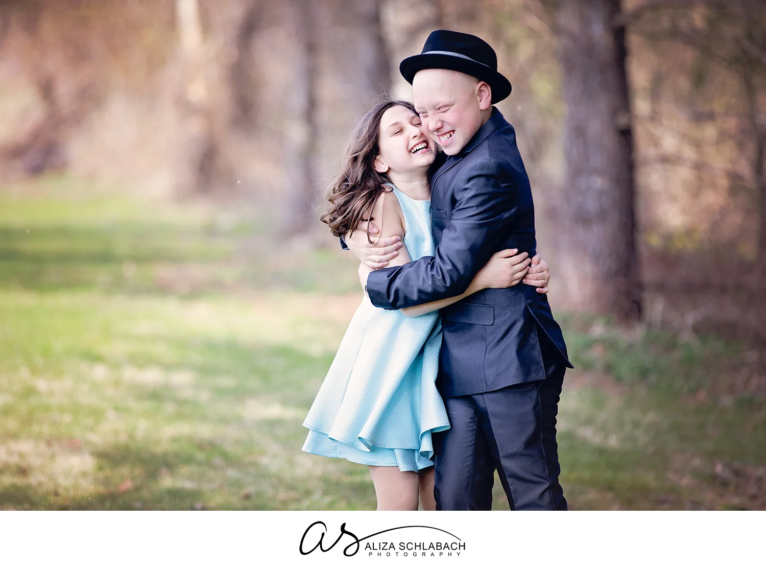 Outdoor portrait of brother and sister hugging