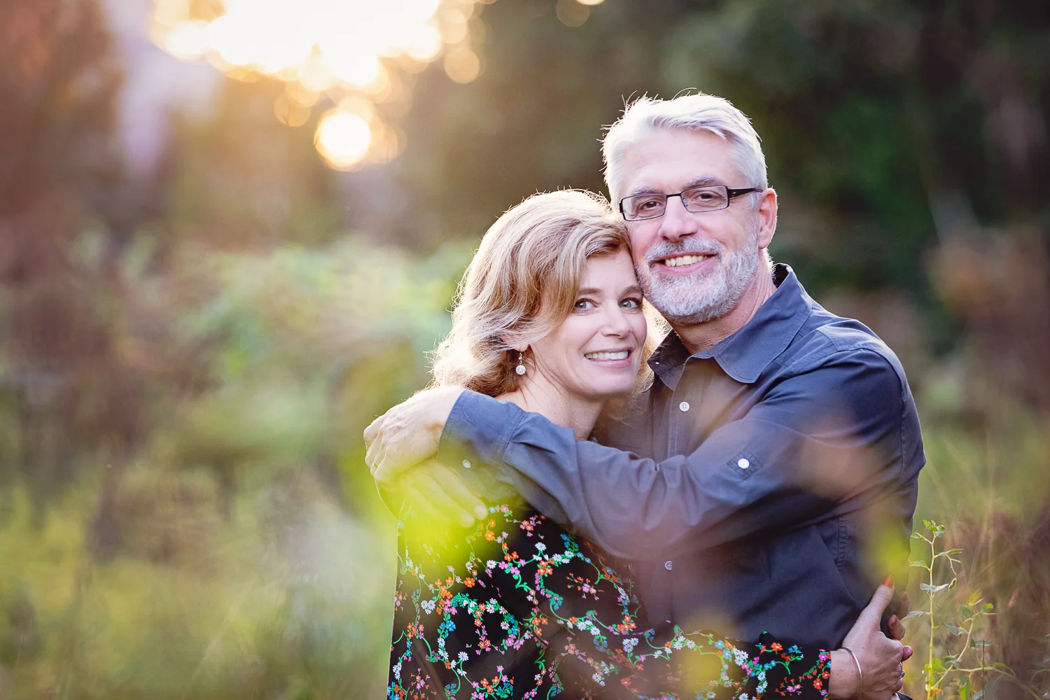 Photo of a distinguished looking couple embracing at golden hour