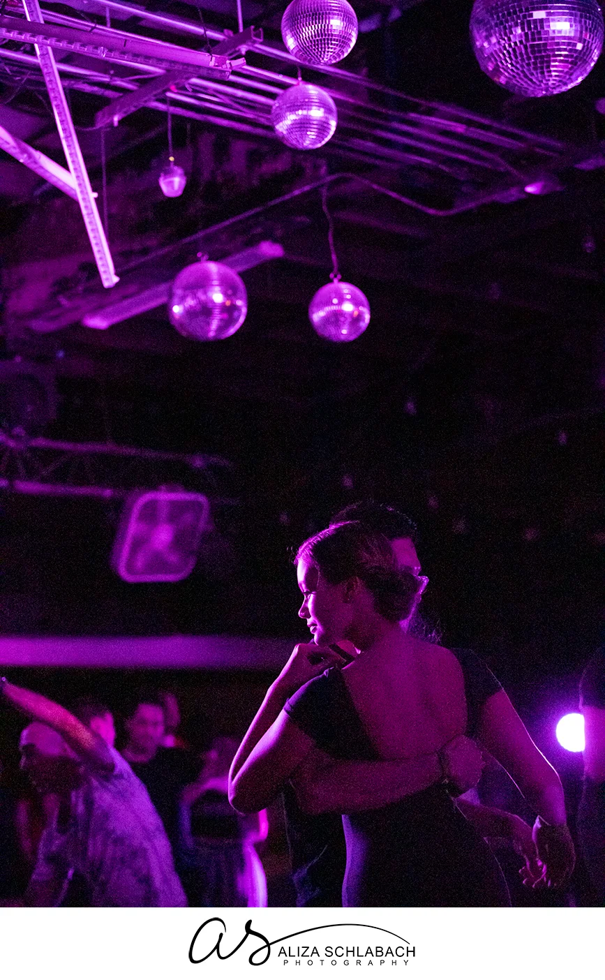 Beautiful partner dancing photo under the light and disco balls