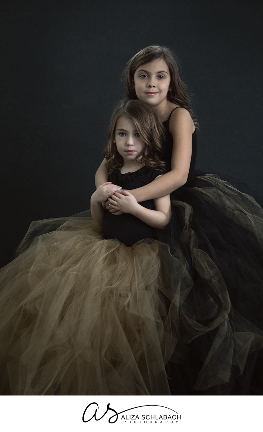 Portrait of young sisters in tulle skirts