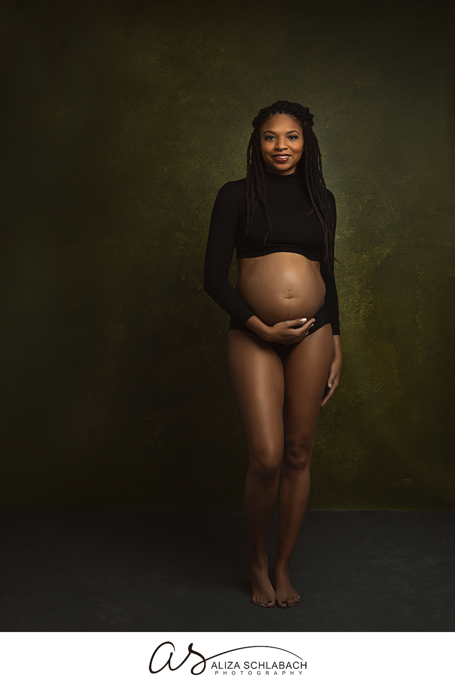 Portrait of a pregnant mother in a black turtleneck
