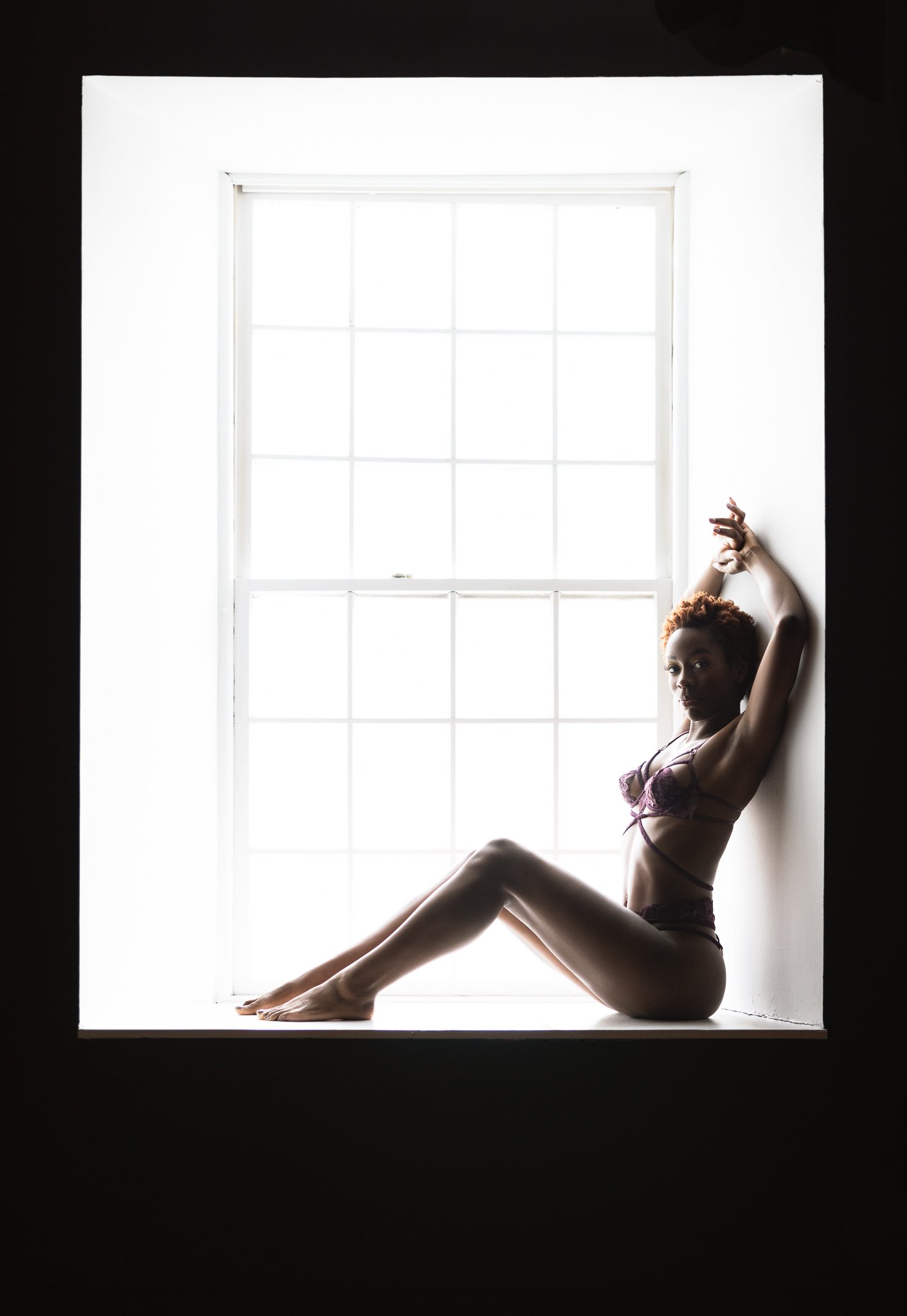 Pretty boudoir photo in a window