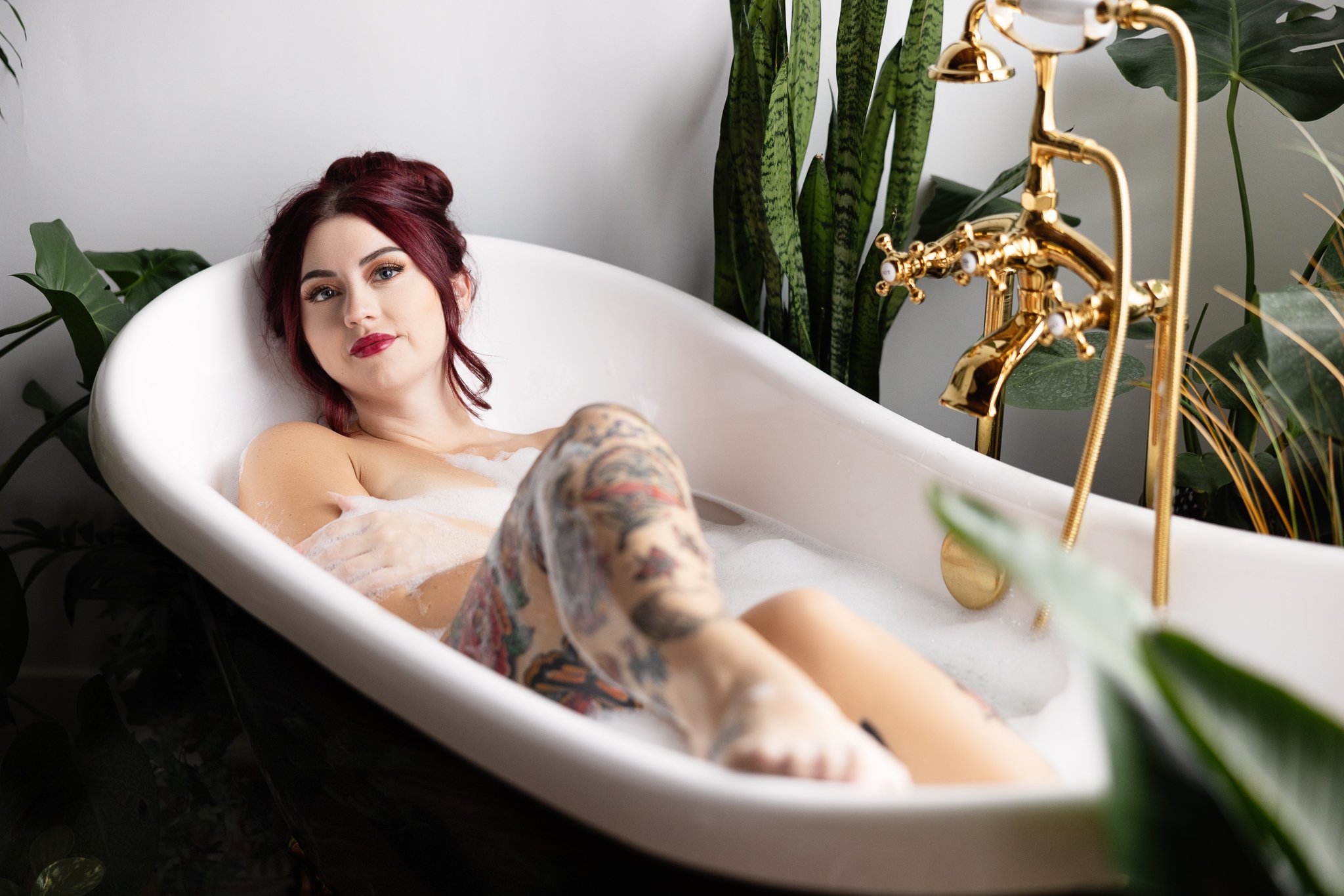 Inked woman in a bubble bath during her Philadelphia boudoir photoshoot