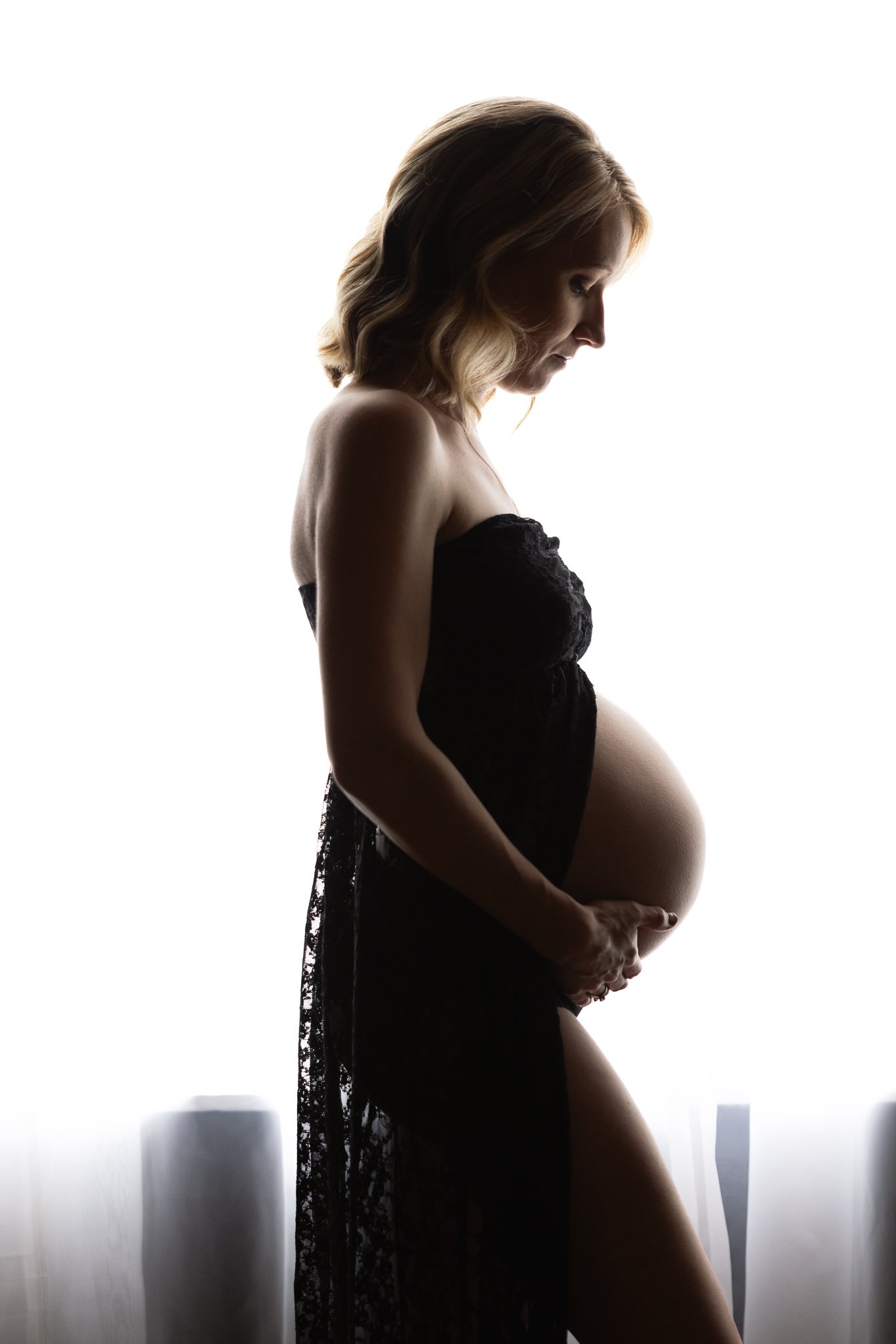 Maternity portrait in front of a window