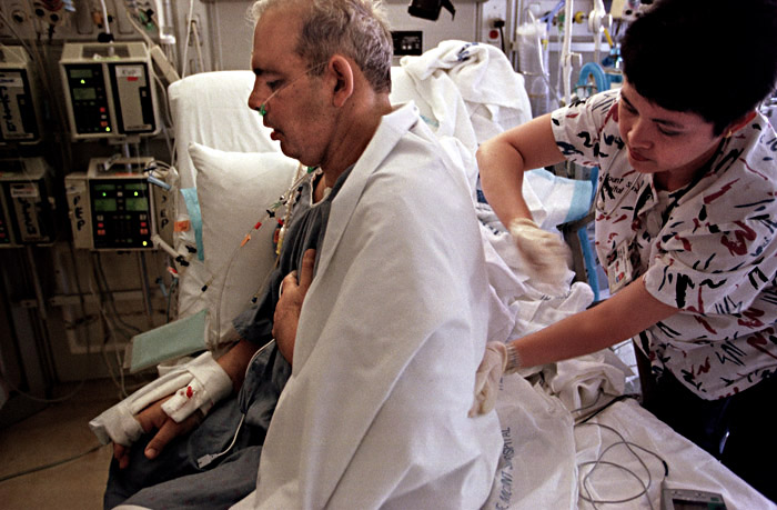 A massage is given to Joe to help clear his lungs and loosen tight muscles less than ten hours after the operation.