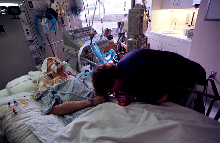 Joan kisses Saul's hand. At this point, he is unconscious and in the last days of his life. 