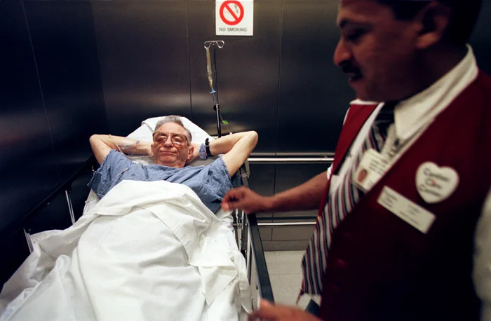 A veteran not only from Korea but also of every test in the hospital, John sleeps on the way to another biopsy.