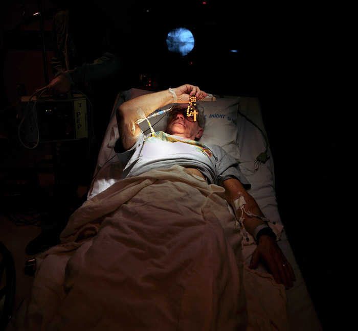 Another biopsy, and John blocks the light with his Rosary.