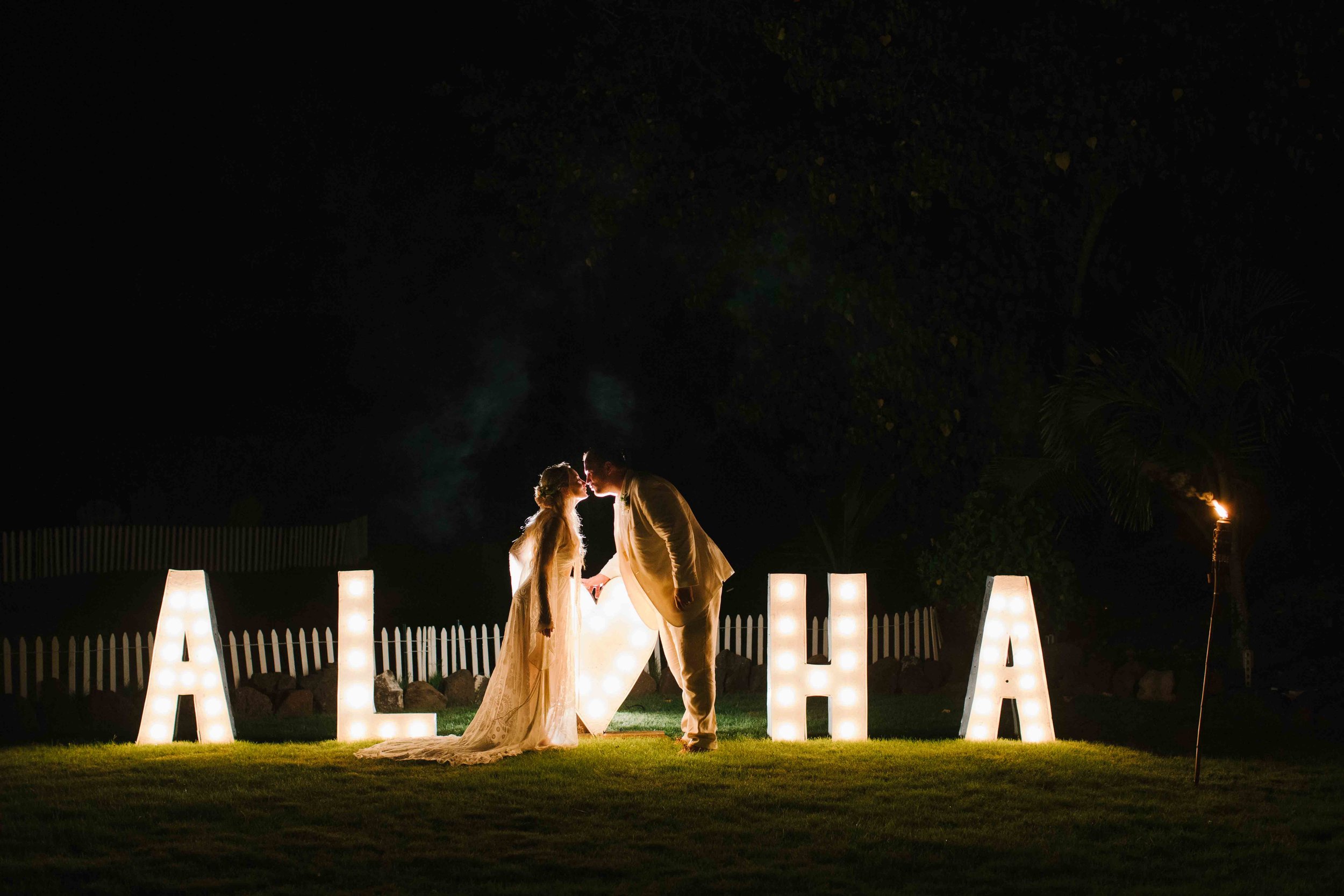 Bride and Groom Kissing with Aloha