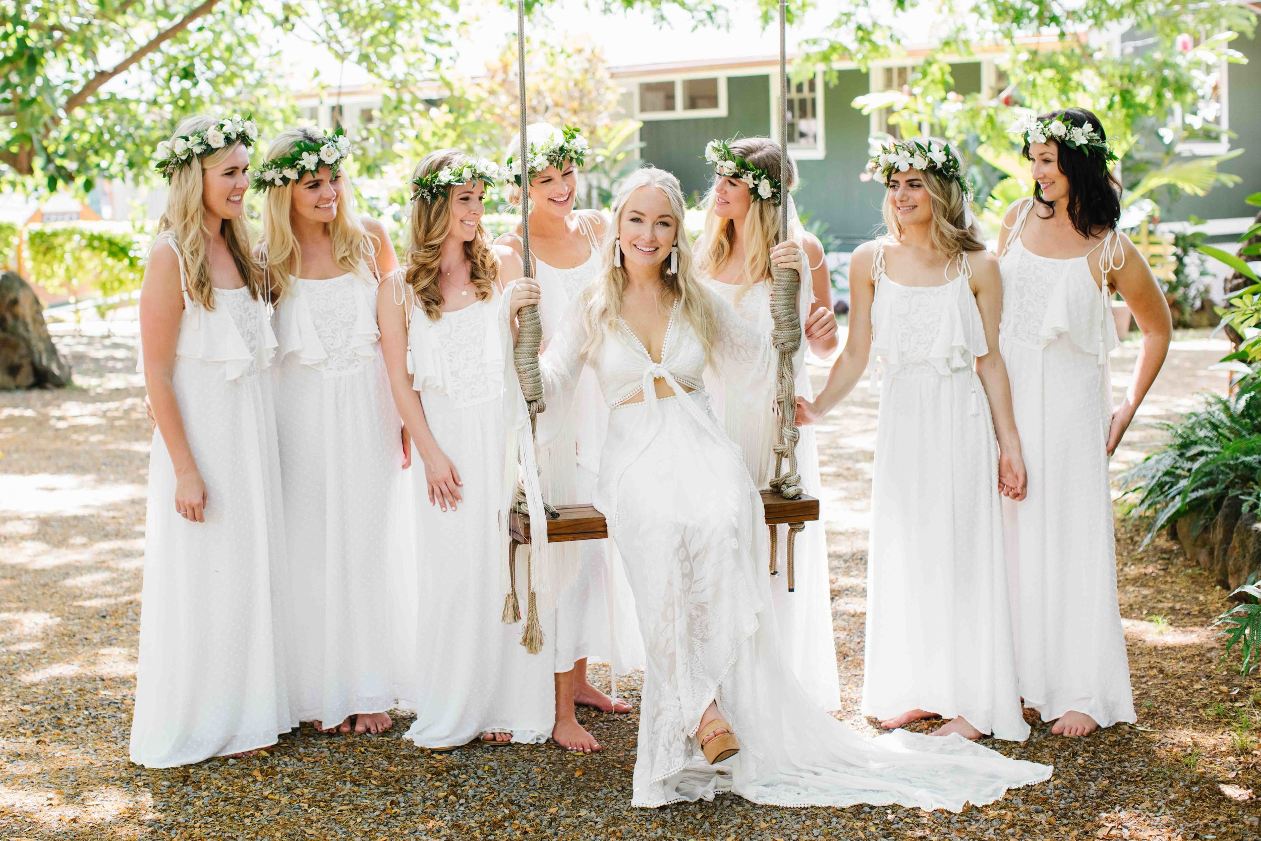 Bride Sitting on a Swing with Bridesmaids