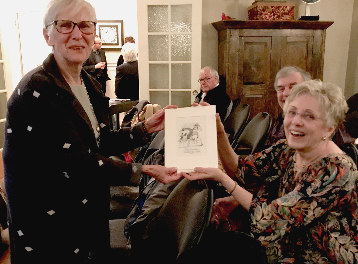  Carole Badgley, Past FANS Board member with Lynn Johnston, 2017 FANS Distinguished Artist winner. With Lynn’s cartoon drawing 