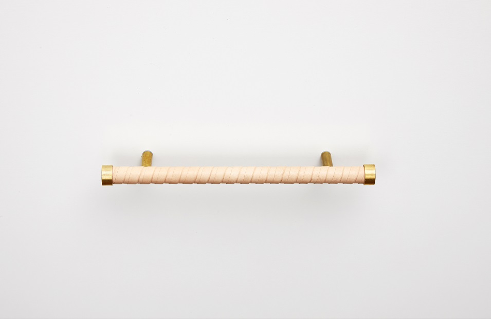 Solid brass handle wrapped in strips of natural skirting leather