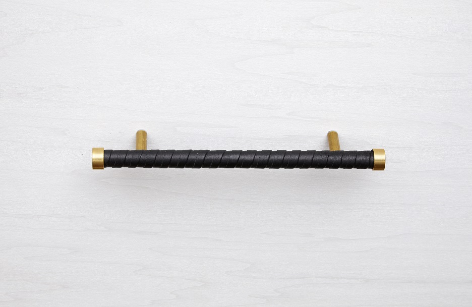Solid brass handle wrapped in strips of black leather